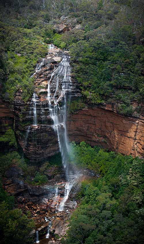 A multi-tier waterfall drops dramatically over various tiers of sandstone (Wentworth Falls, Blue Mountains National Park)